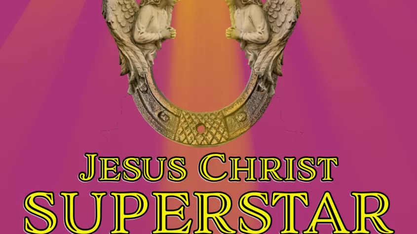 An image of a ray of light highlighting two angels over the title Jesus Christ Superstar