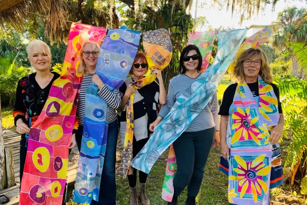 Participants paint beautiful scarves along the Caloosahatchee River. 
